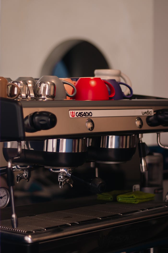 Services Espresso machine with colorful cups on top, ideal for coffee shop visual content.
