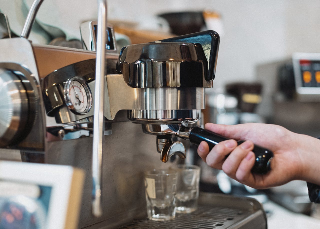 Services Barista preparing espresso with a professional machine in a Tokyo coffee shop.