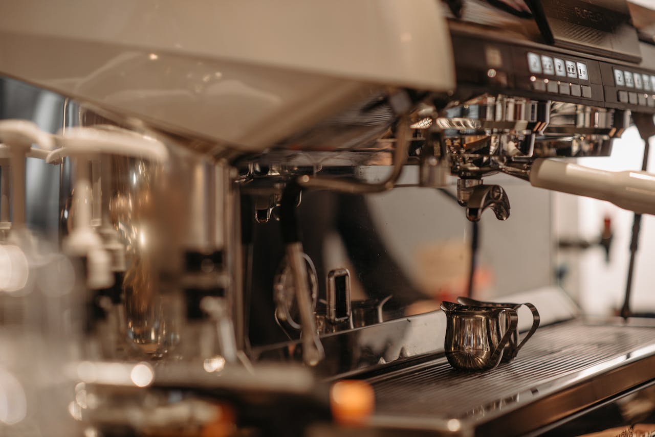 Home Close-up of a professional espresso machine with frothing pitcher, perfect for coffee lovers.